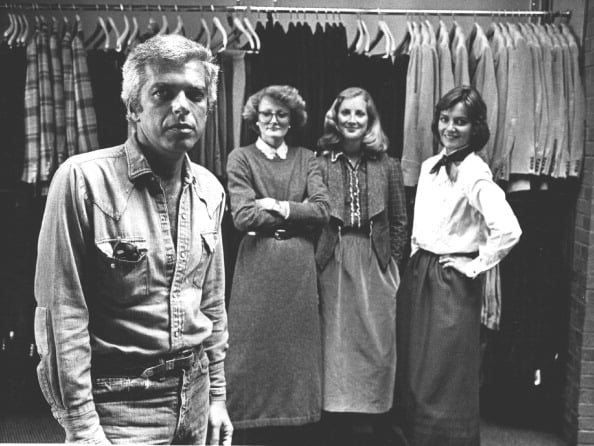 1977 Ralph Lauren poses with women wearing his creations.