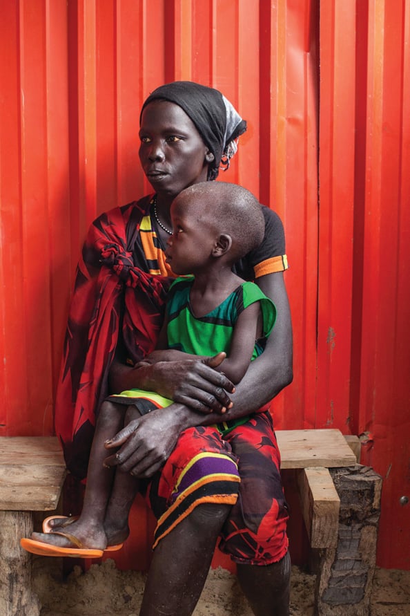 A woman and her malnourished child wait to receive treatment at the Leer Hospital, South Sudan