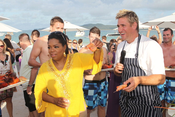Celebrity Australian chef Curtis Stone shows Oprah Winfrey how to put a shrimp on the barbie