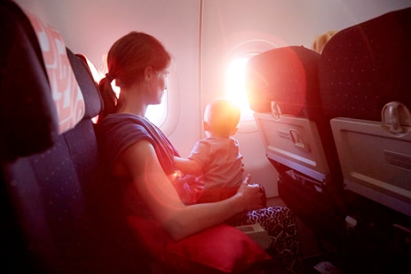 Mother and Baby on airplane looking out of window