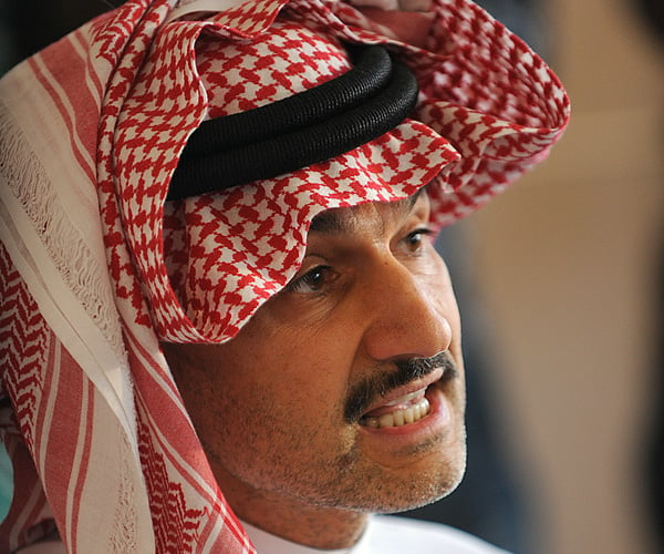 Saudi Prince Alwaleed bin Talal holds a