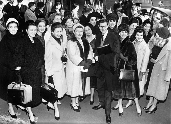 Yves Saint Laurent, the young French fashion designer who succeeded the late Christian Dior, arriving at Victoria Station London with some of his leading models 