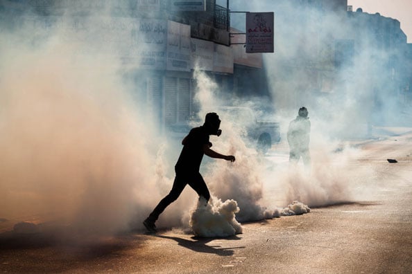  Bahraini protesters between the clouds of tear gas in clashes marking the fourth anniversary of the Gulf coalition,