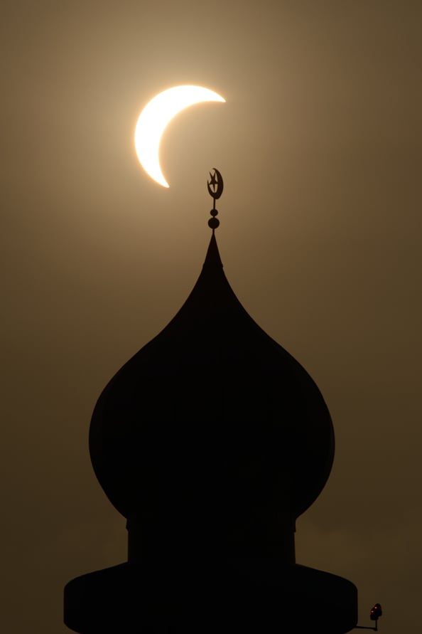 solar eclipse with mosque dome